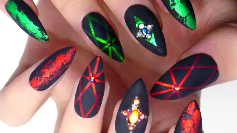 Black pointed nails with green and red accents