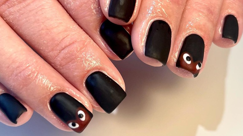 Black nails with eyes on the tips