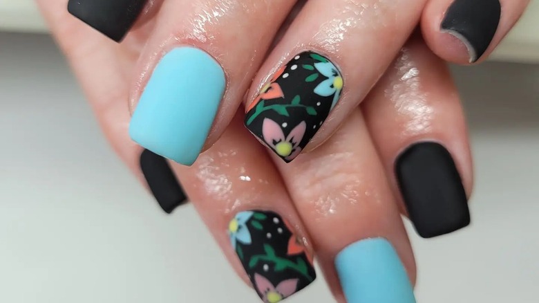 Black nails with colorful hand painted flowers