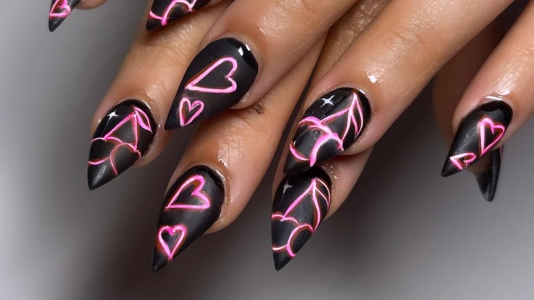 Black nails with neon pink hearts