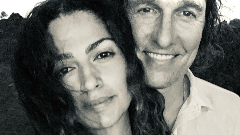 Matthew McConaughey hugging Camila Alves