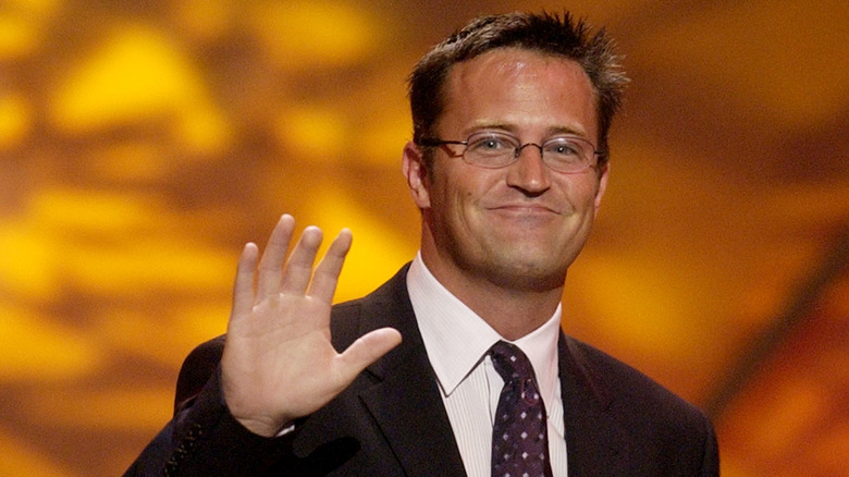 Matthew Perry smiling and waving