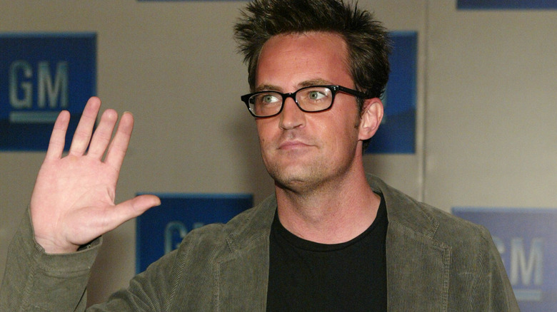 Matthew Perry waves