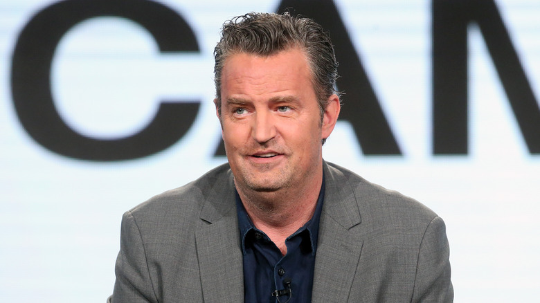 Matthew Perry wearing gray jacket