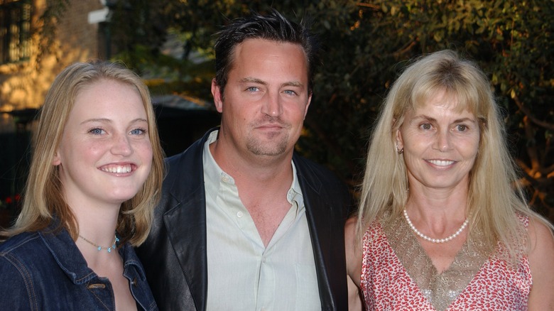 Matthew Perry smiling with his sister and mother