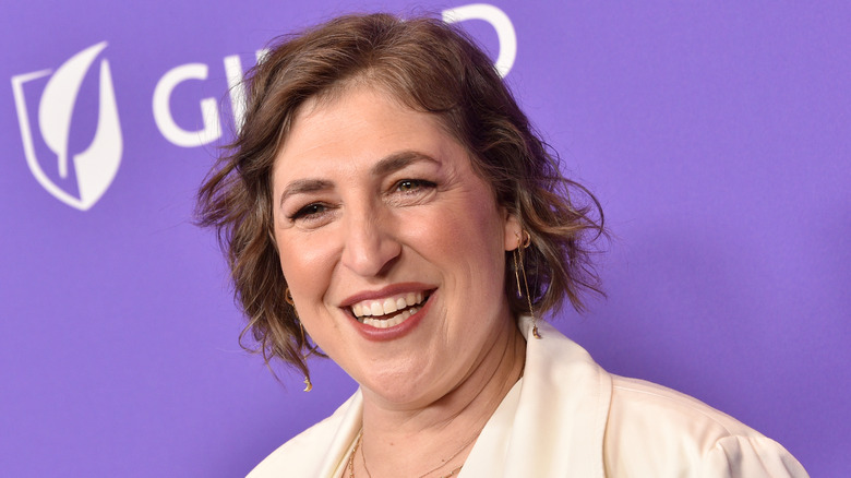 Mayim Bialik smiling at a press event