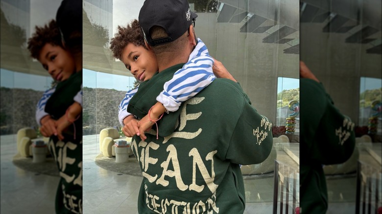 Swizz Beatz holding his son at home