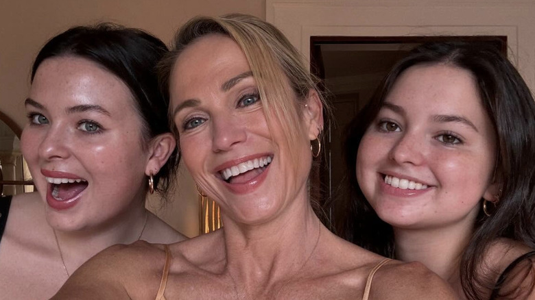 Ava and Annalise McIntosh smile in a selfie with mom Amy Robach in the middle in Spain