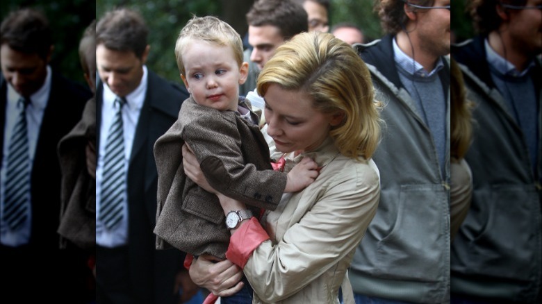 Cate Blanchett holding her son