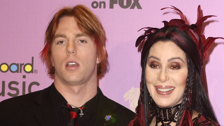 Cher posing for photos with her son Elijah Blue Allman at an event