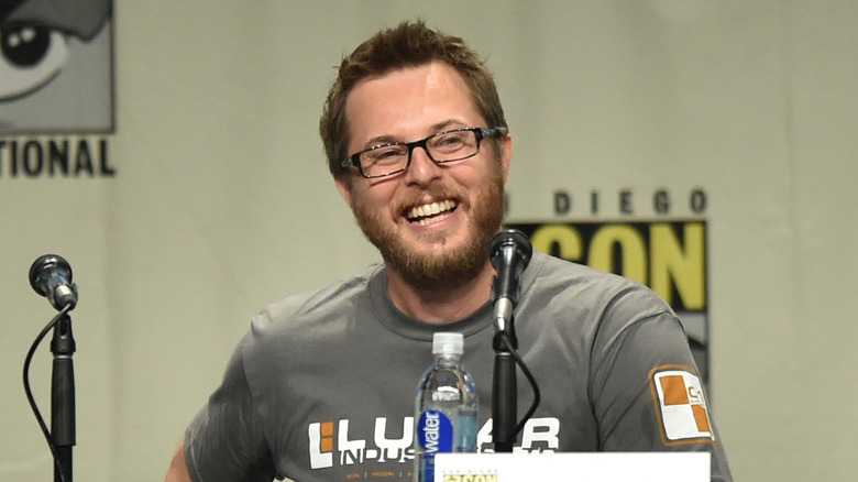 Duncan Jones smiling at a podium 