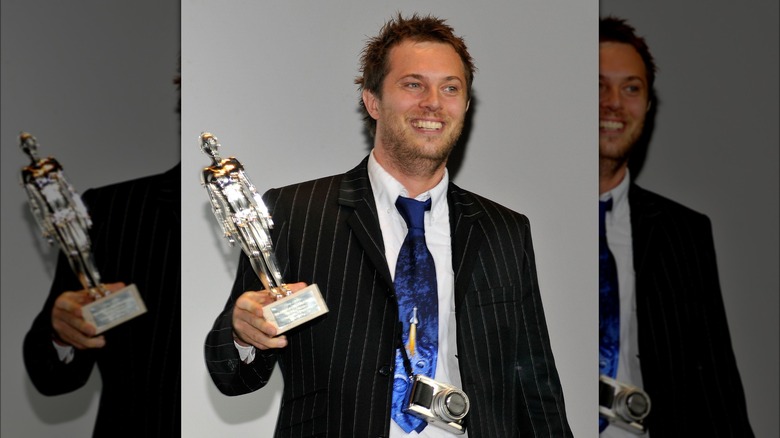 Duncan Jones smiling with film award 