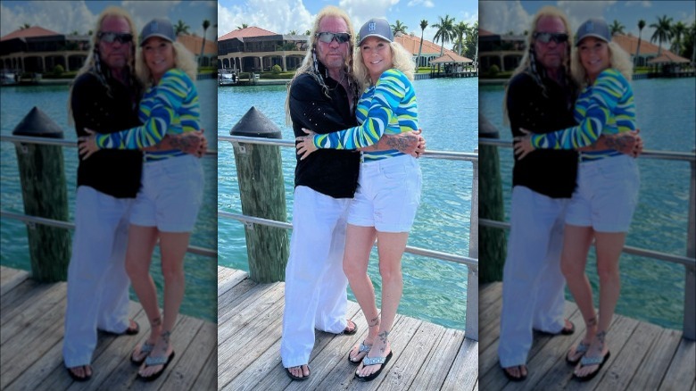 Dog the Bounty Hunter and Francie Frane posing in front of water