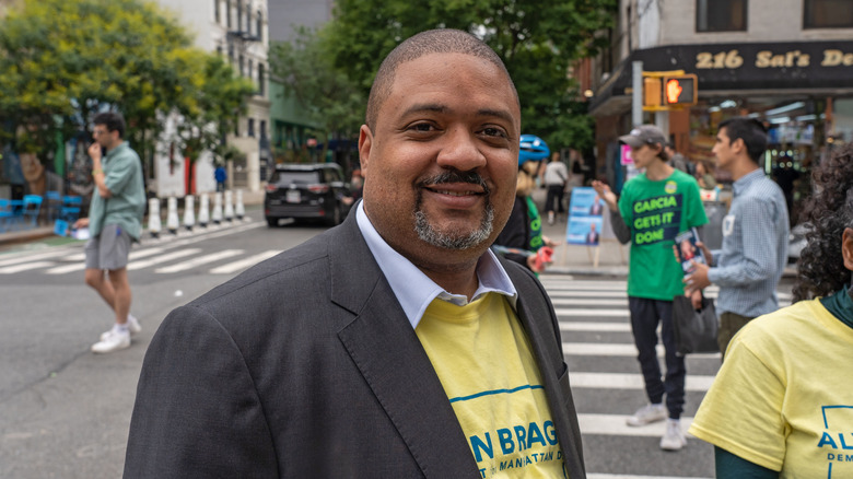 Alvin Bragg smiling on the streets of NYC