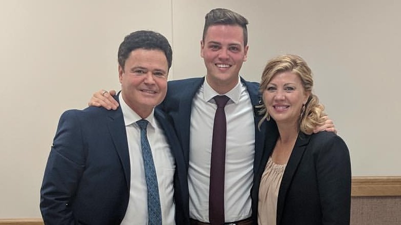 Donnie and Debbie Osmond smiling with son Josh