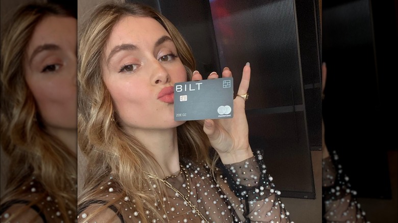 Zoe Oz, holding a Bilt card