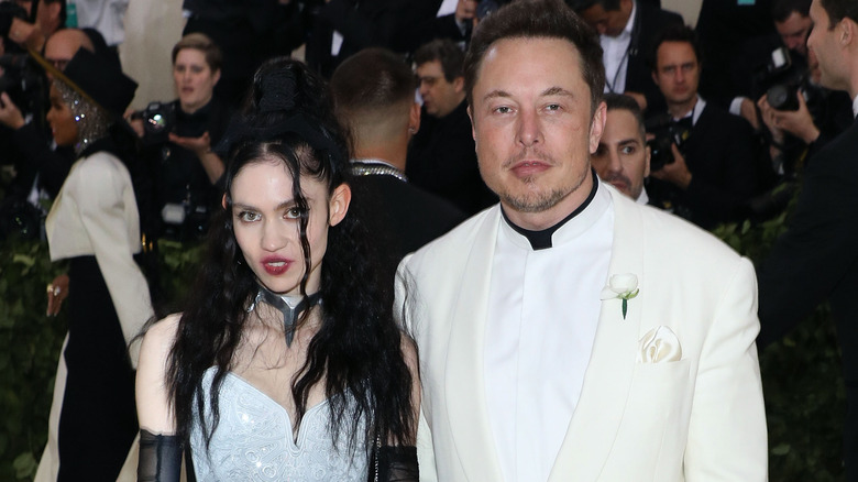 Elon Musk and Grimes posing for photos at the Met Gala