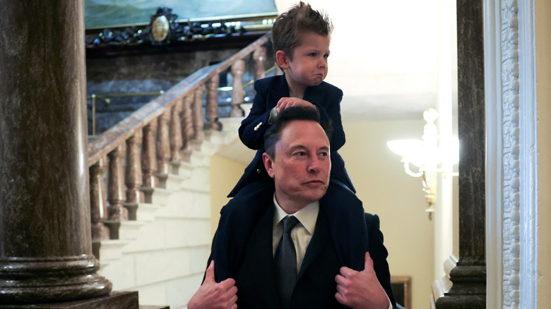 Elon Musk carrying his son on his shoulders