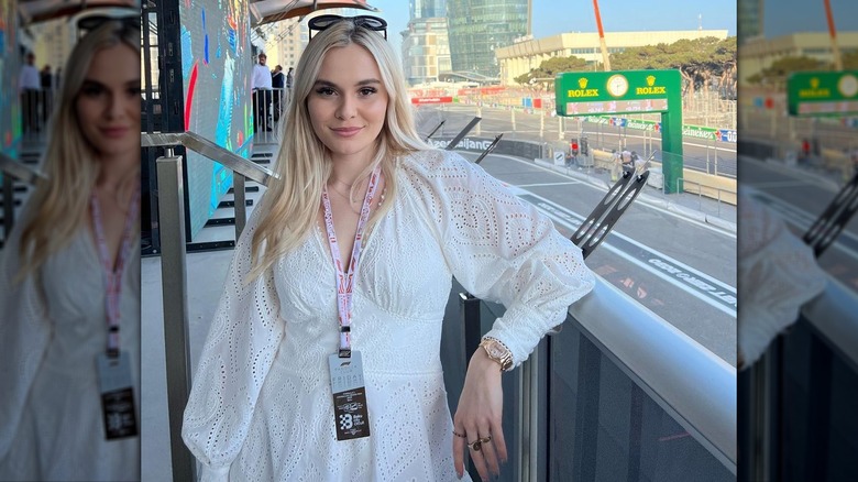 Holly Ramsay stands near racetrack