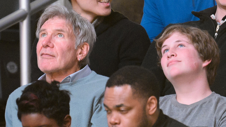 Harrison Ford and Liam Flockhart Ford watching a basketball game