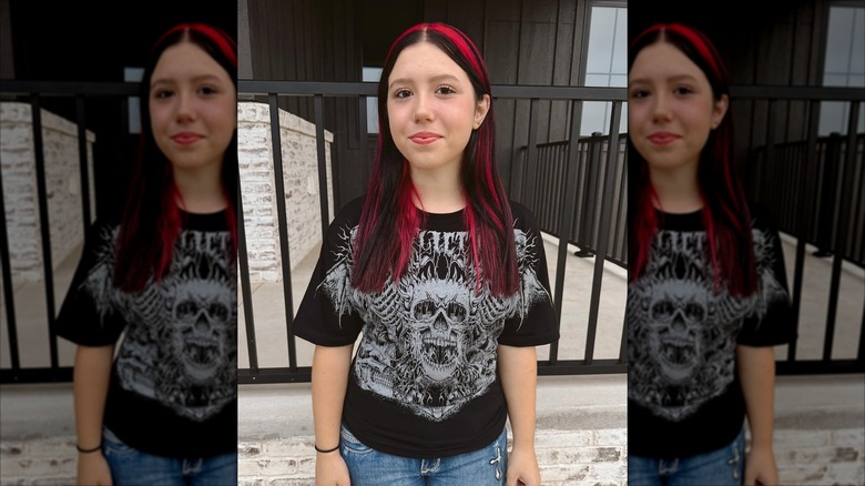 Aubree DeBoer poses in front of a metal fence