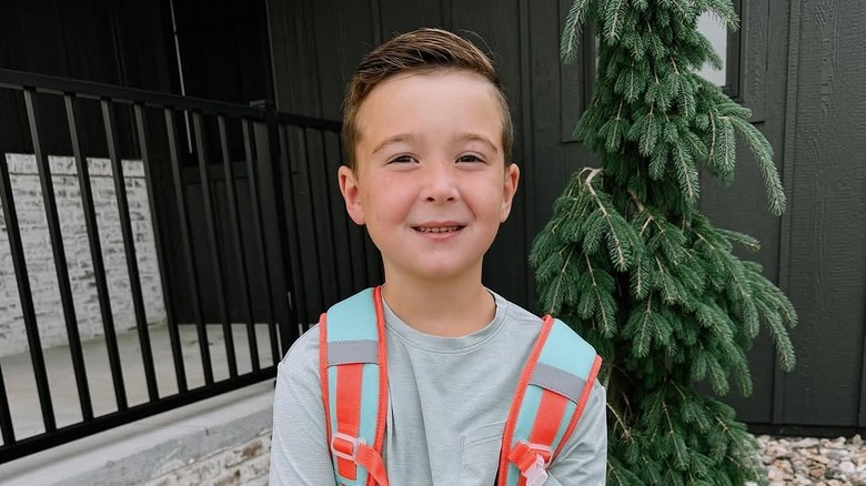 Watson DeBoer smiles for the camera wearing a backpack