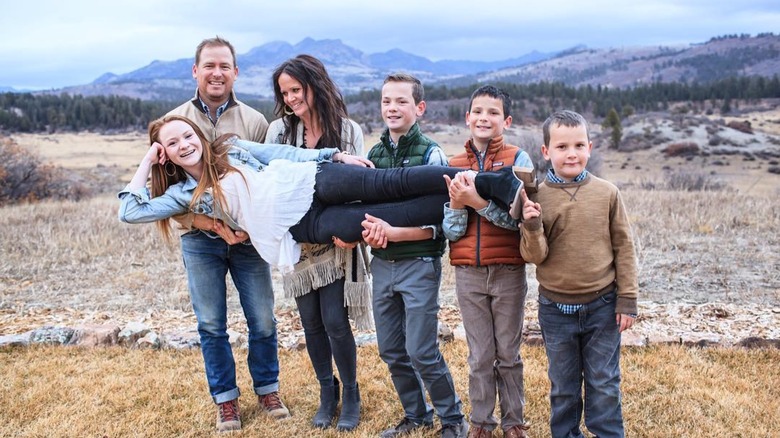 The Dozier family outdoors with mountains in the background