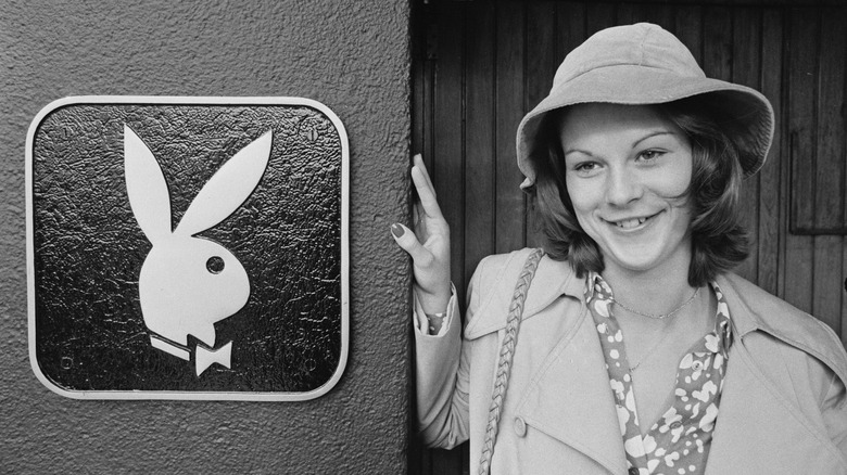 Christie Hefner smiling by Playboy logo