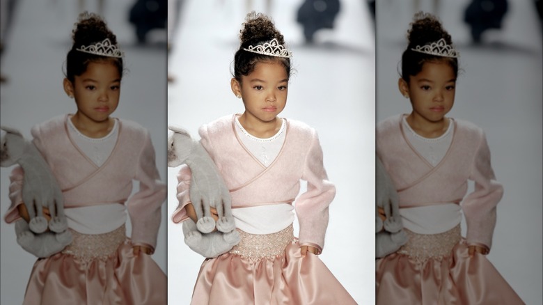 Ming Lee Simmons walking the catwalk as a kid