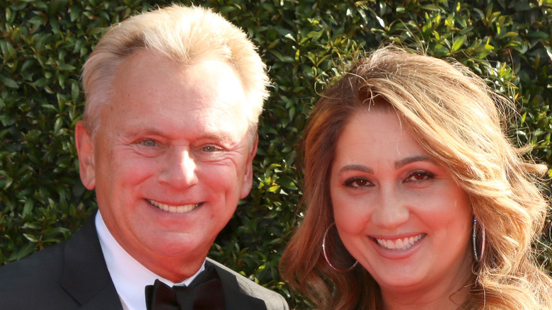 Pat Sajak smiles with Lesly Brown