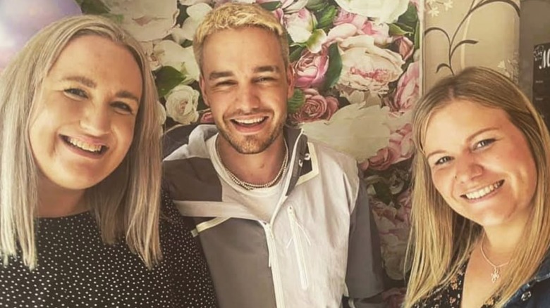 Liam Payne smiling with sisters Nicola and Ruth