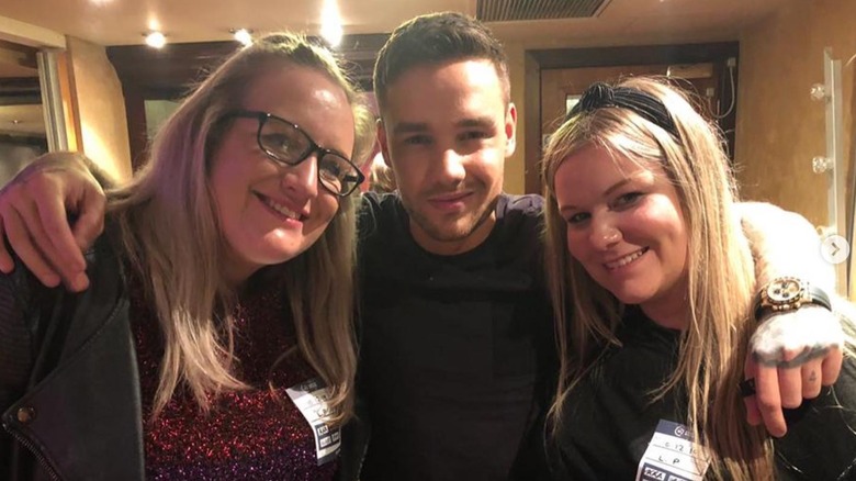 Liam Payne embracing sisters Nicola and Ruth for a photo