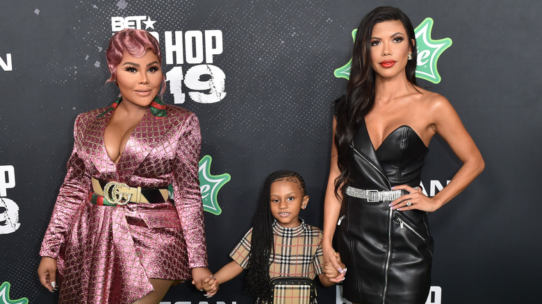 Lil' Kim posing with daughter Royal and friend