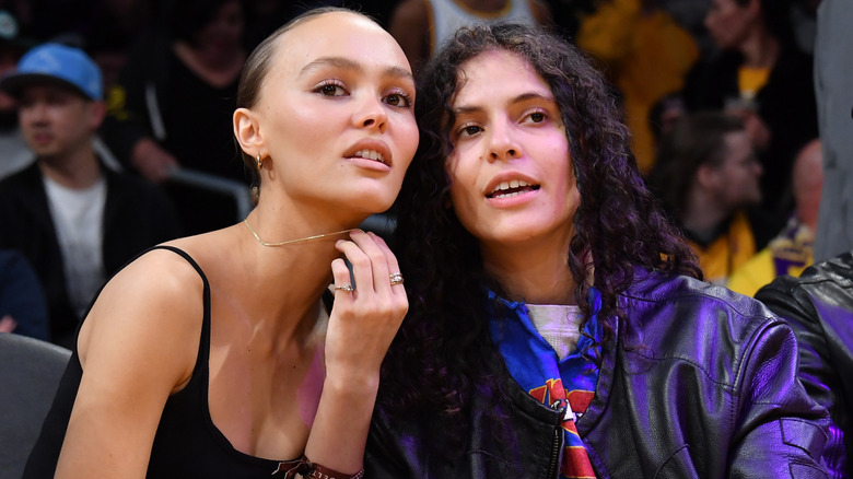 Lily-Rose Depp and 070 Shake sitting in crowd