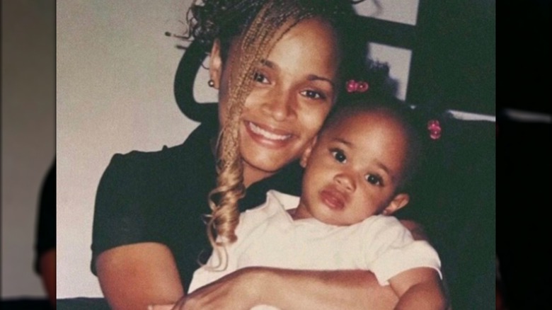 Young Samaria Smith in her smiling mom's arms