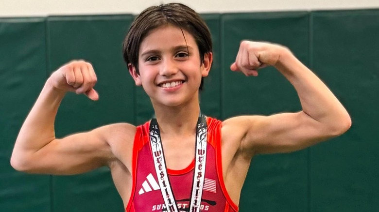 Dominic Lopez smiling and flexing