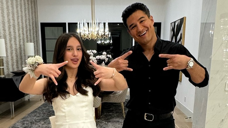 Gia and Mario Lopez smiling and making rock and roll hand gesture