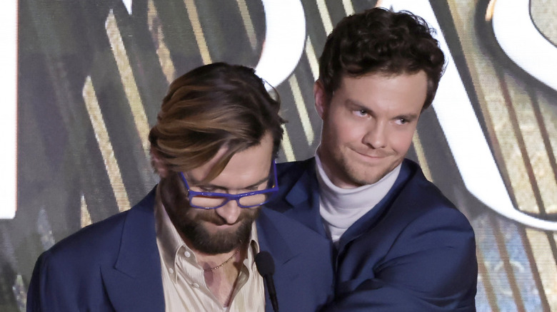 Jack Quaid hugging a friend