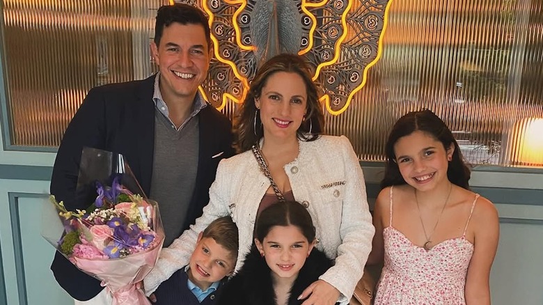 Tom Llamas poses for a family photo with wife and kids