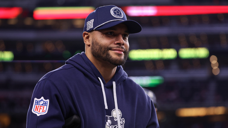 Dak Prescott wearing Dallas Cowboys hat and hoodie