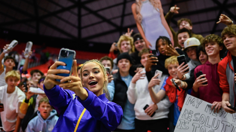 Olivia Dunne talking a selfie with crowd