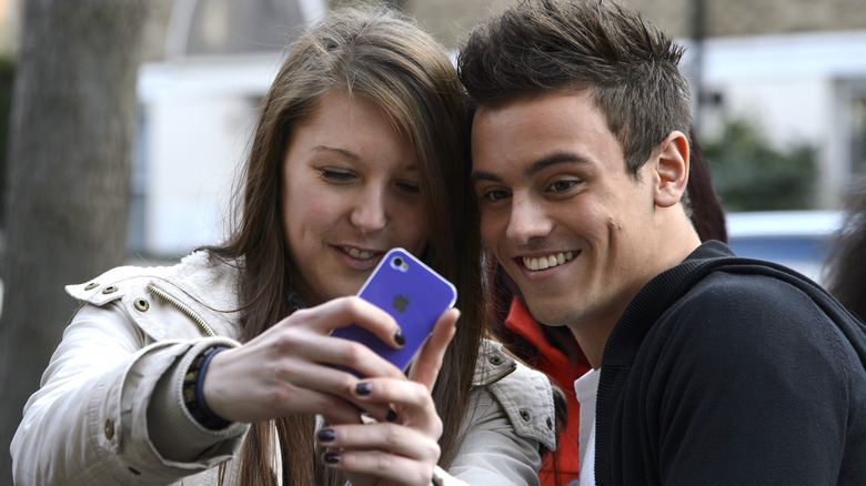 Tom Daley poses for a selfie with girl 