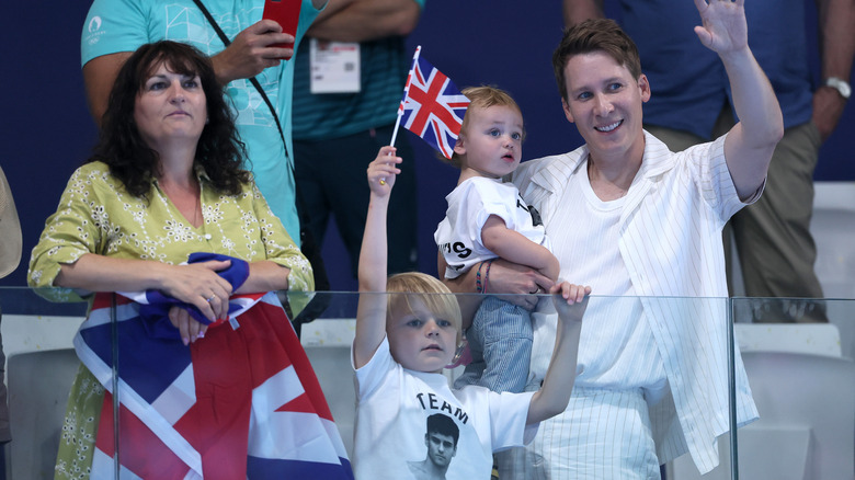 Dustin Lance Black waves with two sons