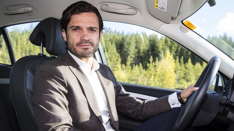 Prince Carl Philip behind the wheel of a car