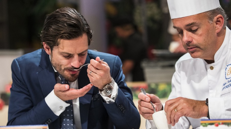 Prince Carl Philip tastes something from a spoon