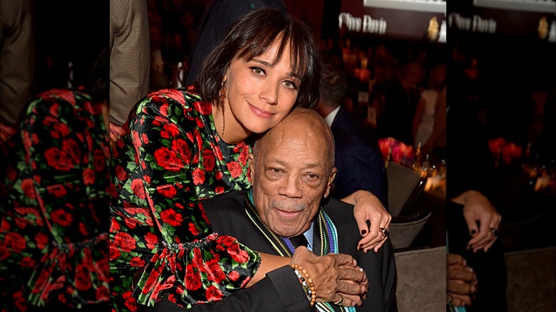 Rashida Jones smiling and hugging Quincy Jones