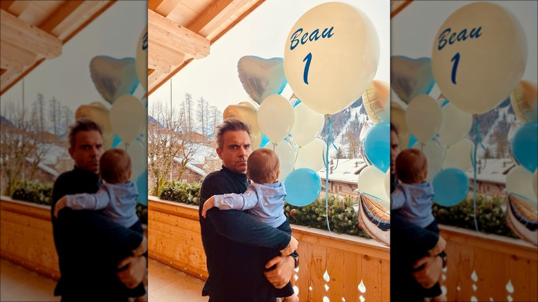 Robbie Williams holding his son Beau