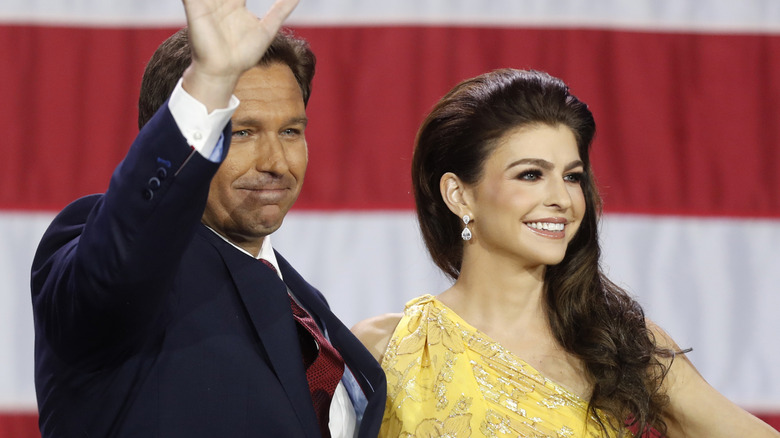 Casey DeSantis and Ron DeSantis smiling and waving