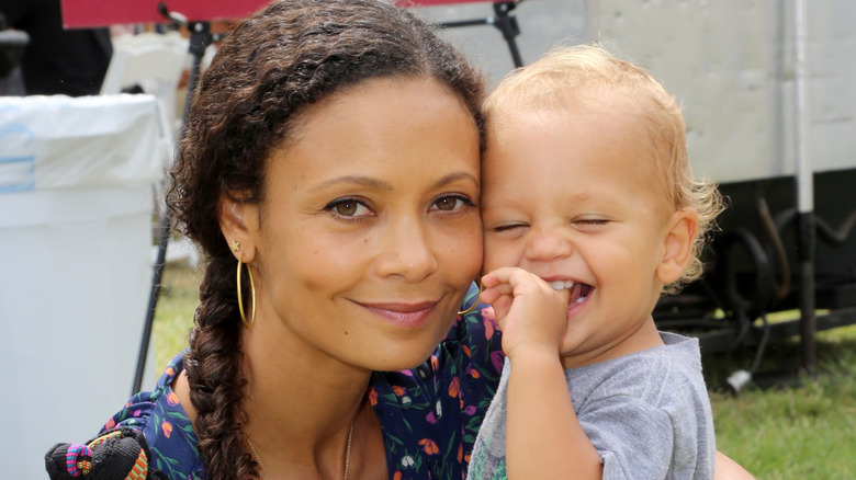 Thandiwe Newton smiling with Booker Parker as a baby