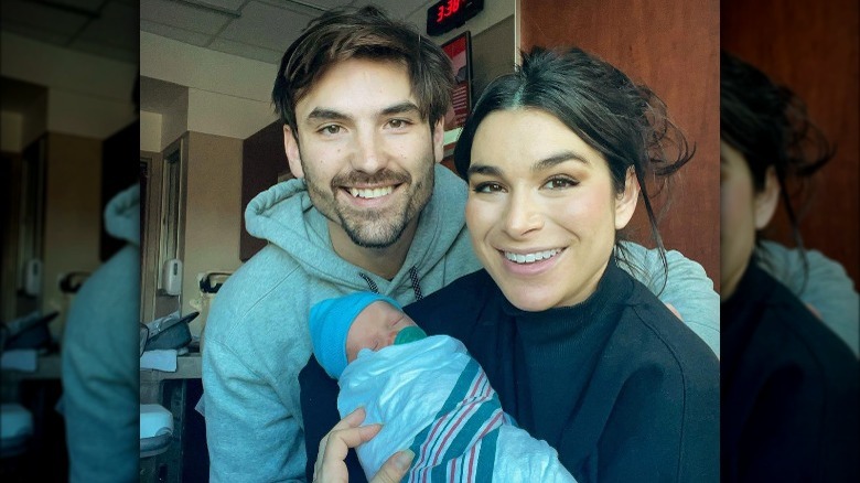 Ashley Iaconetti and Jared Haibon smile together with their newborn son